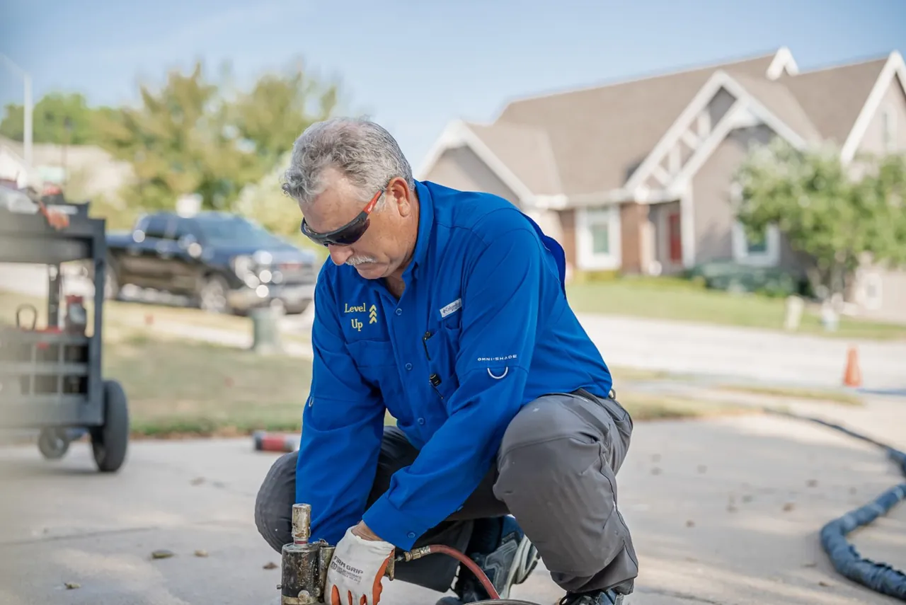 Level Up technician operating concrete lifting equipment